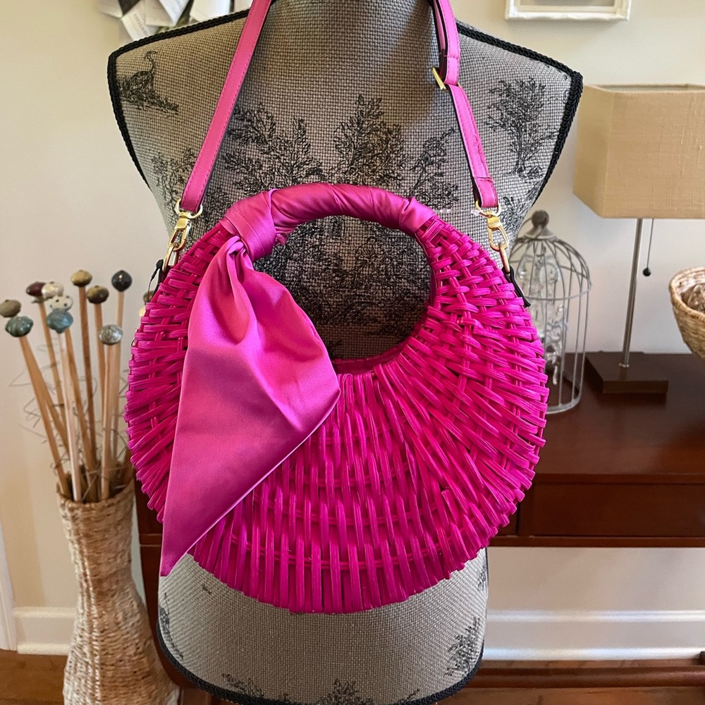 Large Straw Crescent Crossbody Bag. Features a scarf detail. Gold tone hardware.